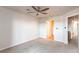 This is an empty bedroom featuring neutral paint, carpet, and a ceiling fan at 13351 W Alameda Pkwy # 203, Lakewood, CO 80228