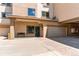 Exterior view of building featuring private entrance, garage parking, and stucco facade at 13351 W Alameda Pkwy # 203, Lakewood, CO 80228