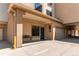 Exterior view of building featuring private entrance, garage parking, and stucco facade at 13351 W Alameda Pkwy # 203, Lakewood, CO 80228