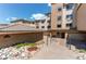 An exterior view of the well-maintained building with tidy landscaping and multiple garages at 13351 W Alameda Pkwy # 203, Lakewood, CO 80228