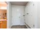 Hallway featuring coat closet and entry to a partial bathroom with a single sink vanity at 13351 W Alameda Pkwy # 203, Lakewood, CO 80228