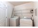 Laundry room with a washer and dryer, wire shelving, and neutral paint at 13351 W Alameda Pkwy # 203, Lakewood, CO 80228