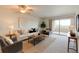 Bright living room featuring neutral paint, plush carpet, and sliding glass doors to a balcony at 13351 W Alameda Pkwy # 203, Lakewood, CO 80228