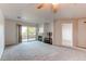 Spacious living room with plush carpet, fireplace, balcony access, and ceiling fan at 13351 W Alameda Pkwy # 203, Lakewood, CO 80228