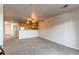 Open concept living space with plush carpet adjacent to the kitchen area at 13351 W Alameda Pkwy # 203, Lakewood, CO 80228