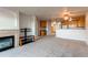 Spacious living room with fireplace, plush carpet, open to the kitchen, and lots of natural light at 13351 W Alameda Pkwy # 203, Lakewood, CO 80228