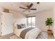 Bright main bedroom with access to a balcony, ceiling fan, and stylish neutral decor at 13351 W Alameda Pkwy # 203, Lakewood, CO 80228