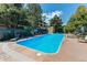 A sparkling blue outdoor pool, surrounded by comfortable lounge chairs and lush landscaping at 13351 W Alameda Pkwy # 203, Lakewood, CO 80228