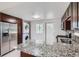 Well-equipped kitchen with stainless steel appliances, island, and granite countertops at 4812 W 8Th Ave, Denver, CO 80204
