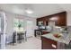 Modern kitchen featuring granite countertops, stainless steel appliances, and rich wood cabinetry at 4812 W 8Th Ave, Denver, CO 80204