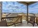 Balcony view with wicker chairs overlooking neighborhood homes at 4815 Cattle Cross Rd, Castle Rock, CO 80104