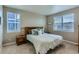 Bright bedroom with carpet flooring, two windows with views, and a comfortable bed at 4815 Cattle Cross Rd, Castle Rock, CO 80104