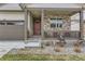 Charming, covered front porch with stone accents and a relaxing seating area at 4815 Cattle Cross Rd, Castle Rock, CO 80104