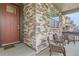 Inviting covered porch with stone pillars and comfortable seating area at 4815 Cattle Cross Rd, Castle Rock, CO 80104