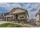 Inviting covered front porch offers charming curb appeal with decorative stone accents at 4815 Cattle Cross Rd, Castle Rock, CO 80104