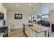 Modern kitchen open to the living room featuring granite countertops and stainless steel appliances at 4815 Cattle Cross Rd, Castle Rock, CO 80104