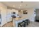 Bright kitchen features an island with granite countertop, stainless steel appliances, and white cabinets at 4815 Cattle Cross Rd, Castle Rock, CO 80104