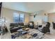 Well-lit living room featuring a comfortable seating arrangement and stylish decor at 4815 Cattle Cross Rd, Castle Rock, CO 80104