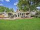 Expansive backyard with an outdoor seating area and mature trees at 6359 S Locust Way, Centennial, CO 80111