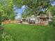 Large backyard with a composite deck, outdoor dining, and mature trees at 6359 S Locust Way, Centennial, CO 80111