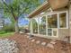 A cozy backyard features large windows, a seating area, and mature landscaping at 6359 S Locust Way, Centennial, CO 80111