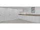 Basement featuring white cabinets, granite counters, and bi-fold doors at 6359 S Locust Way, Centennial, CO 80111