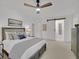 Spacious bedroom with a large bed, ceiling fan and a barn door leading to the bathroom at 6359 S Locust Way, Centennial, CO 80111