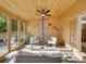 Bright and airy sunroom with wood paneling and an antique stove for an amazing cozy space at 6359 S Locust Way, Centennial, CO 80111