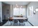 Elegant dining room with modern lighting, a large table, and a window at 1345 W 67Th Pl, Denver, CO 80221