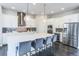 Stylish kitchen with a large center island, modern appliances, and seating at 1345 W 67Th Pl, Denver, CO 80221