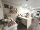 Bright kitchen with pendant lighting, floating shelves, and quartz countertops at 1345 W 67Th Pl, Denver, CO 80221