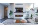 Cozy living room featuring a modern fireplace, TV, and comfortable seating at 1345 W 67Th Pl, Denver, CO 80221