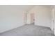 Spacious bedroom with grey carpet and access to the hallway at 2121 S Troy Way, Aurora, CO 80014