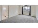 Bedroom with grey carpet, window, and access to a full bathroom at 2121 S Troy Way, Aurora, CO 80014