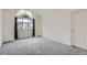 Cozy bedroom with a large window providing natural light and new gray carpet at 2121 S Troy Way, Aurora, CO 80014