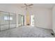 Large bedroom with mirrored closet doors and ensuite bathroom access at 2121 S Troy Way, Aurora, CO 80014