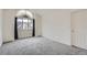 Well-lit bedroom with arched window and grey carpeting at 2121 S Troy Way, Aurora, CO 80014