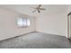 Spacious bedroom with ceiling fan and grey carpeting at 2121 S Troy Way, Aurora, CO 80014
