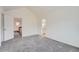 Bright bedroom with carpet, and access to bathroom and upper hallway at 2121 S Troy Way, Aurora, CO 80014