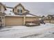 Townhouse exterior with attached garage and snow covered driveway at 2121 S Troy Way, Aurora, CO 80014