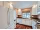 Bright kitchen features white cabinetry, wood floors, and stainless steel appliances at 2121 S Troy Way, Aurora, CO 80014