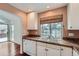 Kitchen features granite countertops, white cabinets and a double sink at 2121 S Troy Way, Aurora, CO 80014