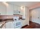 Kitchen with white cabinets, granite countertops, and microwave at 2121 S Troy Way, Aurora, CO 80014