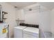 Laundry room with washer, dryer, and storage cabinets at 2121 S Troy Way, Aurora, CO 80014