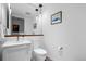 Clean, minimalist bathroom with white fixtures, a modern mirror, and a simple color scheme at 1750 Wewatta St # 700, Denver, CO 80202