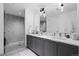 Elegant bathroom features double sinks, sleek cabinets, and a tiled shower with glass door at 1750 Wewatta St # 700, Denver, CO 80202