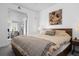 Comfortable bedroom with bed, stylish lamps, and a doorway view into the dining room at 1750 Wewatta St # 700, Denver, CO 80202