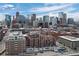 An expansive city view featuring numerous commercial skyscrapers under a bright blue sky with scattered clouds at 1750 Wewatta St # 700, Denver, CO 80202