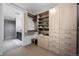 Well-organized closet features custom shelving and drawers, with a glimpse into a tiled bathroom at 1750 Wewatta St # 700, Denver, CO 80202
