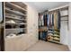 Organized walk-in closet with custom shelving and ample storage space for clothes and shoes at 1750 Wewatta St # 700, Denver, CO 80202